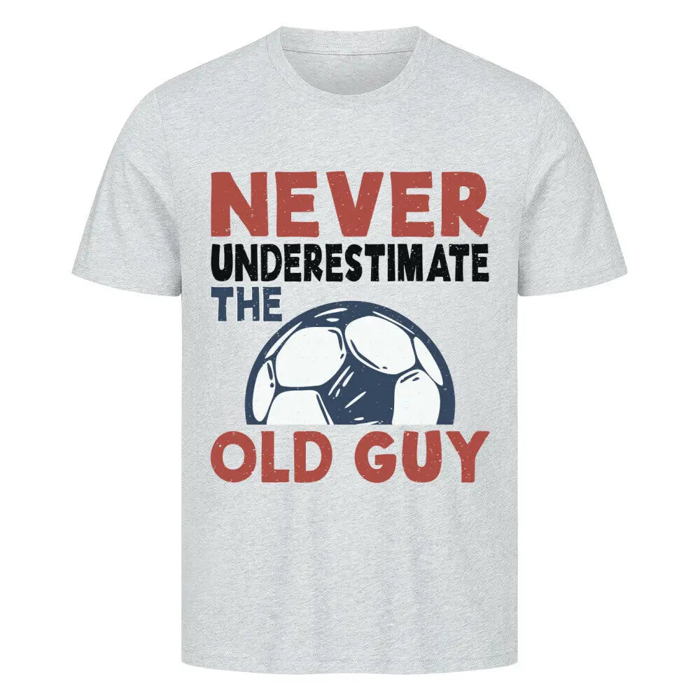 Premium T-shirts Never Underestimate the Old Guy: Graues T-Shirt mit auffälligem Statement „Never underestimate the old guy“ in Rot, Schwarz, Blau und Fußball-Zeichnung